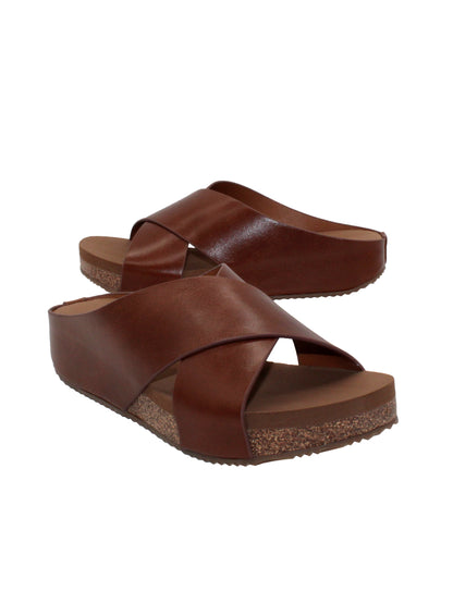 Rustic genuine leather brown Slip-on crisscross sandal style Round toe shape Ultra-comfort EVA insole Cork covered wedge Rubber traction outsole Approx. 1.25” heel height 3/4 angle