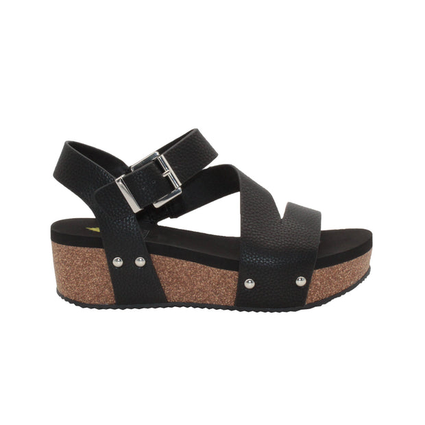 Vegan leather or heavy canvas asymmetrical upper Synthetic lining Adjustable metal buckle and metal clog studs Asymmetrical sandal with back strap Ultra comfort EVA insole Cork wedge Rubber traction outsole Approx. 2” heel height black side
