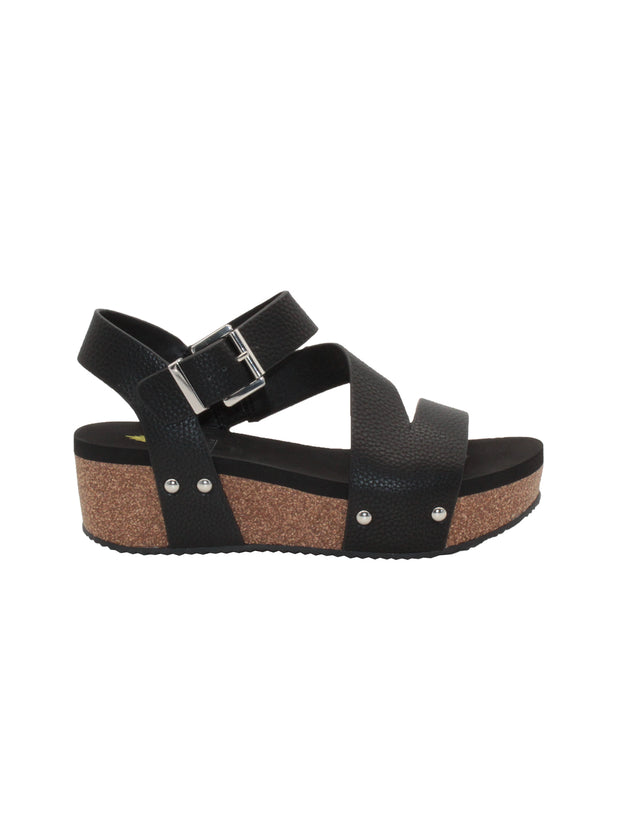 Vegan leather or heavy canvas asymmetrical upper Synthetic lining Adjustable metal buckle and metal clog studs Asymmetrical sandal with back strap Ultra comfort EVA insole Cork wedge Rubber traction outsole Approx. 2” heel height black side