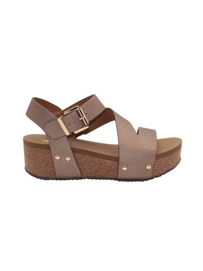 Vegan leather or heavy canvas asymmetrical upper Synthetic lining Adjustable metal buckle and metal clog studs Asymmetrical sandal with back strap Ultra comfort EVA insole Cork wedge Rubber traction outsole Approx. 2” heel height bronze side