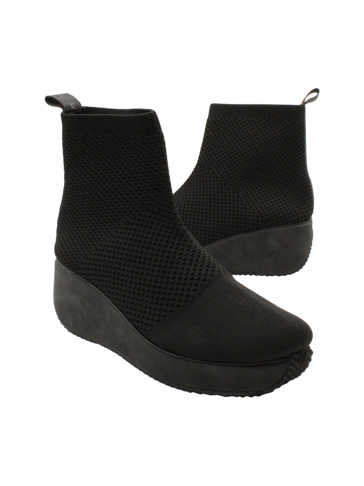Stretch knit upper Stretch knit lining Pull-on wedge bootie with back pull tab Padded insole Round toe shape Rubber traction outsole Approx. 5” shaft height Approx. 2.25” heel height