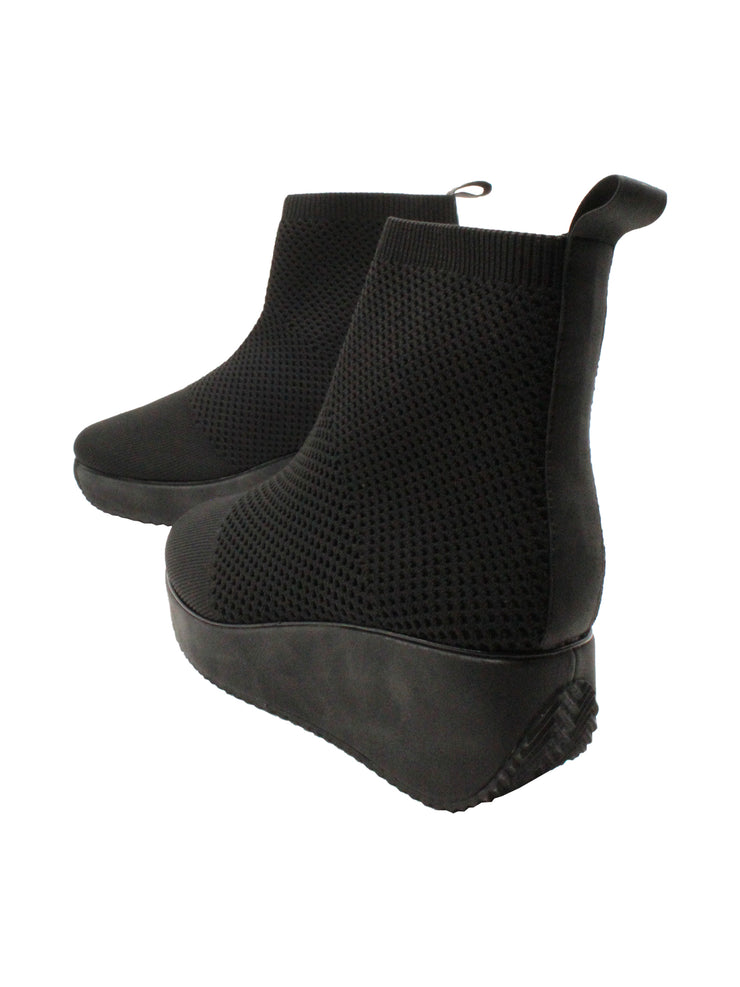 Stretch knit upper Stretch knit lining Pull-on wedge bootie with back pull tab Padded insole Round toe shape Rubber traction outsole Approx. 5” shaft height Approx. 2.25” heel height back