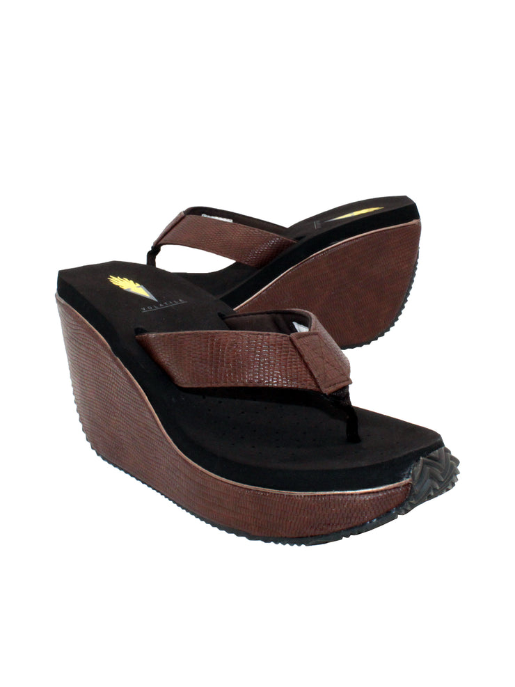  Volatile’s ‘Canova’ platform wedge sandals have been made from faux embossed lizard in super versatile neutral tones. The classic thong style has a soft fabric post that rests gently between your toes and our signature ultra-comfort EVA insole provides all day comfort. Wear yours with anything from midi skirts to cropped jeans. brown
