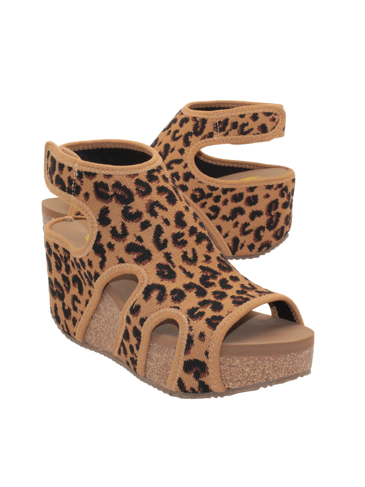 The leopard Chalet cut out sandal wedge by Volatile features a stretch knit upper inspired by running shoes set upon our signature ultra comfort EVA insole. The cork wedge is stationed on a rubber traction outsole that offers stability on all surfaces. 3/4 angle