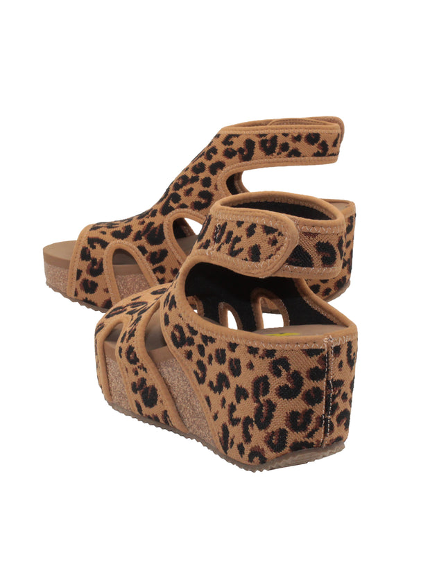 The leopard Chalet cut out sandal wedge by Volatile features a stretch knit upper inspired by running shoes set upon our signature ultra comfort EVA insole. The cork wedge is stationed on a rubber traction outsole that offers stability on all surfaces. back