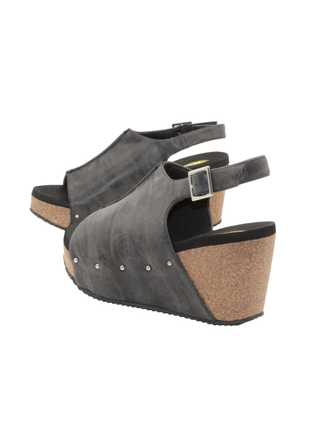 One of Volatile’s classic signature styles, the black Division wedge sandal brings ultra-comfort to casual fashion like no other. The adjustable ankle strap offers stability, the padded lining and signature ultra-comfort EVA insole keeps feet feeling rested even after a full day of adventure, and the rubber traction outsole means these are safe for walking on any surface. Pack these for your next trip to wear with shorts for sightseeing and a flowy dress for special events. 4