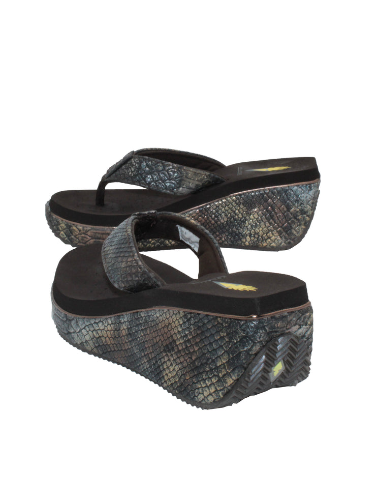 Volatile’s bestselling Frappachino wedge sandal is a style that transcends the trends and is available in our classic black and brown genuine leather versions, or, in this season’s new metallic embossed snake print for a fresh update. They feature Volatile’s signature ultra comfort EVA insole for all day comfort. brown metal snake 4