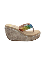 Volatile’s Glimpse platform wedge sandal’s leather upper straps are embellished with sparkling rhinestones. The classic thong style has a soft fabric post that rests gently between your toes, and the signature ultra-comfort EVA insole provides all day comfort. Perfect for special occasions, they’ll complement everything from dresses to jeans. beige multi