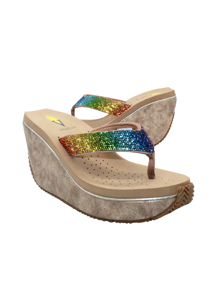 Volatile’s Glimpse platform wedge sandal’s leather upper straps are embellished with sparkling rhinestones. The classic thong style has a soft fabric post that rests gently between your toes, and the signature ultra-comfort EVA insole provides all day comfort. Perfect for special occasions, they’ll complement everything from dresses to jeans. beige multi 2
