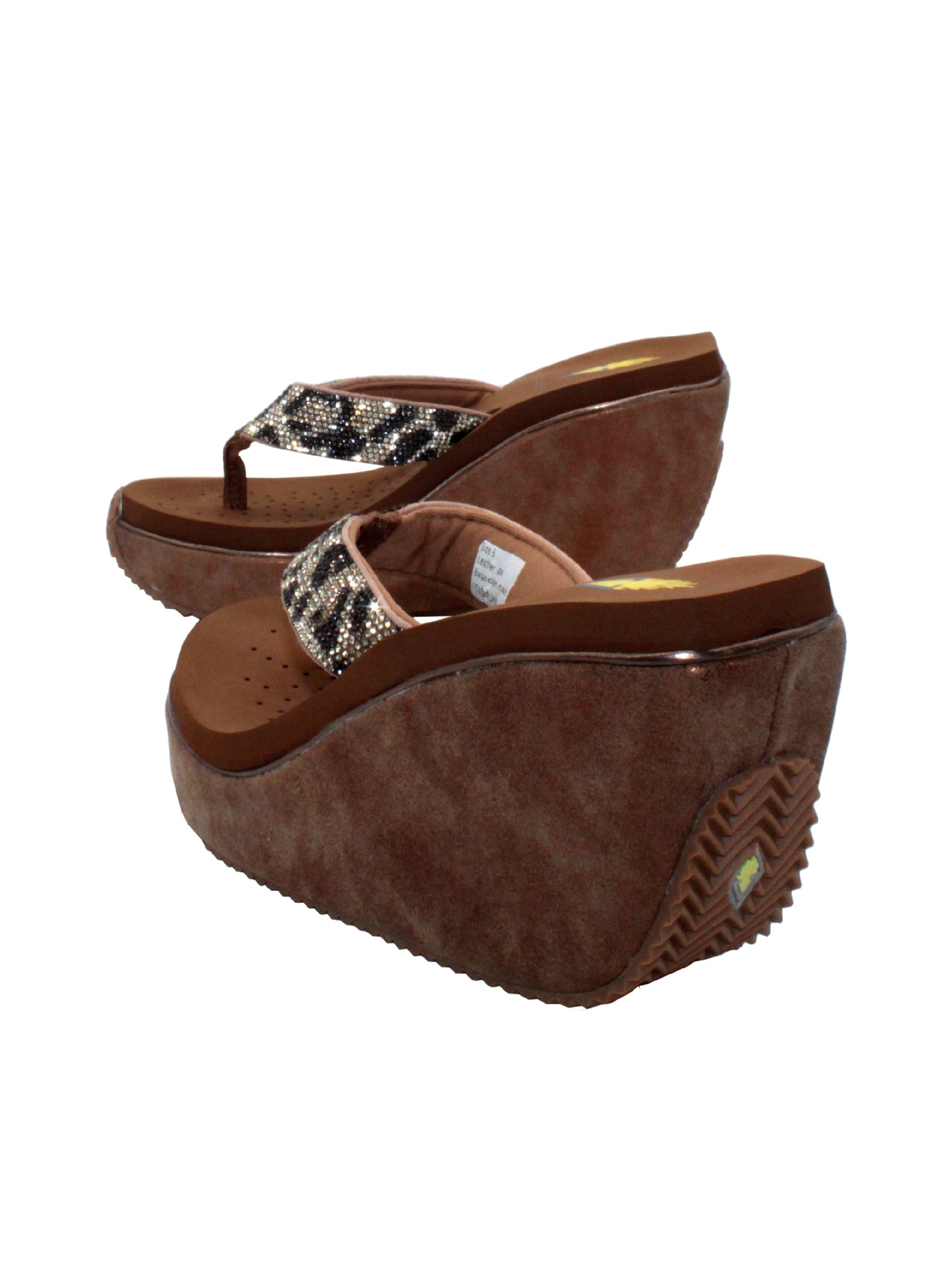 Volatile’s Glimpse platform wedge sandal’s leather upper straps are embellished with sparkling rhinestones. The classic thong style has a soft fabric post that rests gently between your toes, and the signature ultra-comfort EVA insole provides all day comfort. Perfect for special occasions, they’ll complement everything from dresses to jeans. tan multi 4