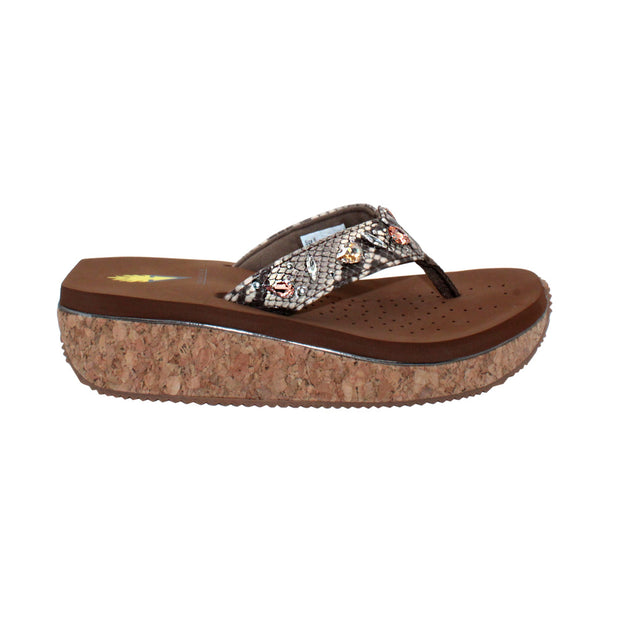 The Grand thong wedge sandal by Volatile is crafted in a textured synthetic python material adorned with cased jewels and studs. They feature Volatile’s signature ultra comfort EVA insole for all day comfort, padded textile lining and nonskid rubber traction outsoles to keep you at your best on your feet. Feel free to dress these up or down for any occasion.