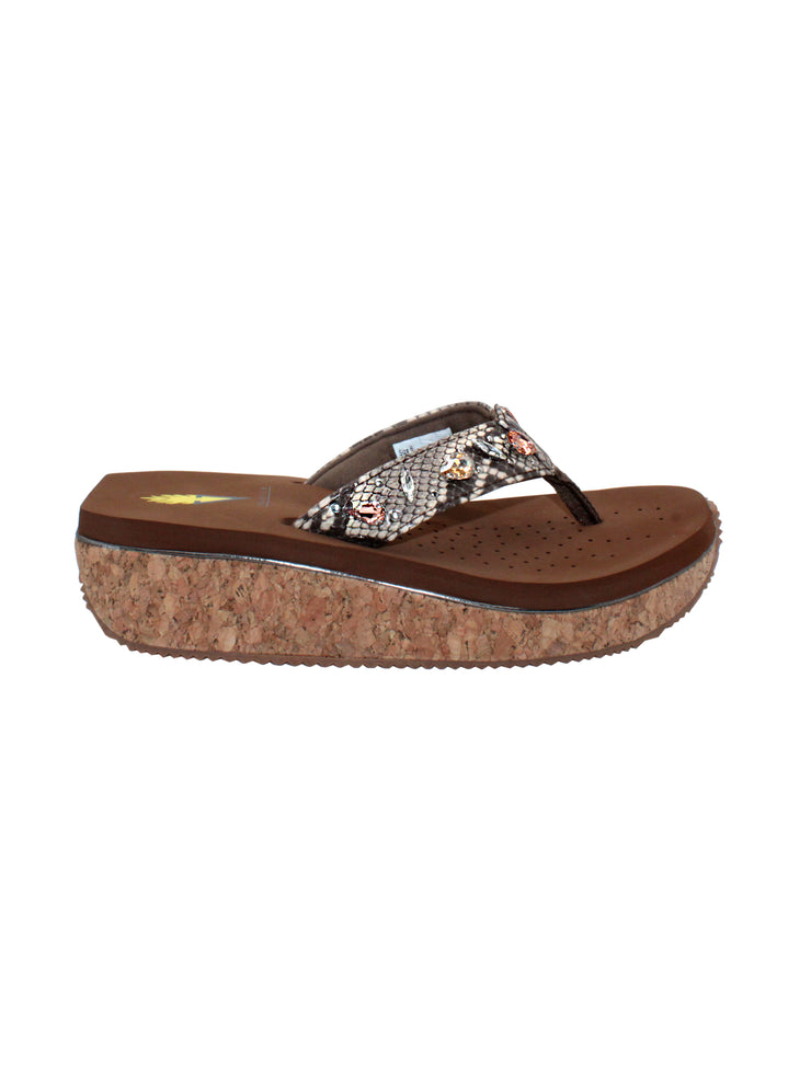 The Grand thong wedge sandal by Volatile is crafted in a textured synthetic python material adorned with cased jewels and studs. They feature Volatile’s signature ultra comfort EVA insole for all day comfort, padded textile lining and nonskid rubber traction outsoles to keep you at your best on your feet. Feel free to dress these up or down for any occasion.