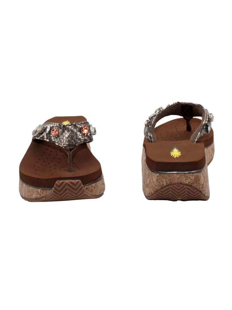  The Grand thong wedge sandal by Volatile is crafted in a textured synthetic python material adorned with cased jewels and studs. They feature Volatile’s signature ultra comfort EVA insole for all day comfort, padded textile lining and nonskid rubber traction outsoles to keep you at your best on your feet. Feel free to dress these up or down for any occasion.3
