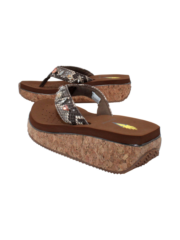 The Grand thong wedge sandal by Volatile is crafted in a textured synthetic python material adorned with cased jewels and studs. They feature Volatile’s signature ultra comfort EVA insole for all day comfort, padded textile lining and nonskid rubber traction outsoles to keep you at your best on your feet. Feel free to dress these up or down for any occasion. 4