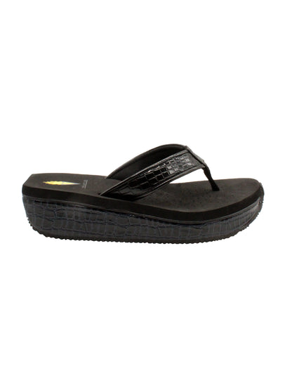 The Mini Croco thong wedge sandal by Volatile is crafted from a luxe, glossy faux crocodile material and gives a modest lift in height with the comfortable 1 1/2” wedge. They feature Volatile’s signature ultra comfort EVA insole for all day comfort, padded textile lining that rests gently on the skin, and nonskid rubber traction outsoles to keep feet grounded on all surfaces.  black