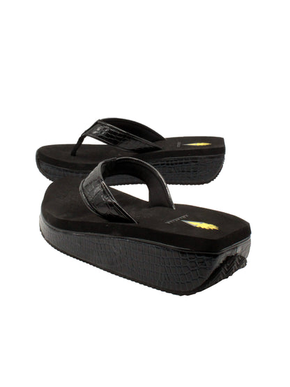 The Mini Croco thong wedge sandal by Volatile is crafted from a luxe, glossy faux crocodile material and gives a modest lift in height with the comfortable 1 1/2” wedge. They feature Volatile’s signature ultra comfort EVA insole for all day comfort, padded textile lining that rests gently on the skin, and nonskid rubber traction outsoles to keep feet grounded on all surfaces.  black 4