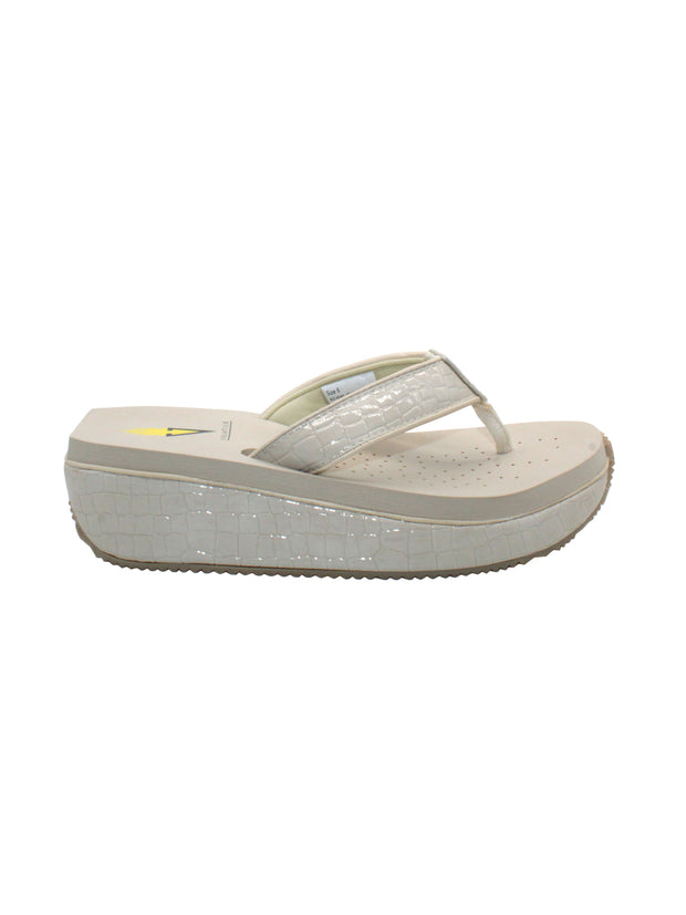 The Mini Croco thong wedge sandal by Volatile is crafted from a luxe, glossy faux crocodile material and gives a modest lift in height with the comfortable 1 1/2” wedge. They feature Volatile’s signature ultra comfort EVA insole for all day comfort, padded textile lining that rests gently on the skin, and nonskid rubber traction outsoles to keep feet grounded on all surfaces.  off white 