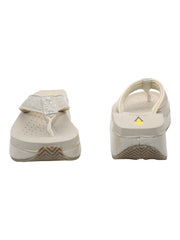The Mini Croco thong wedge sandal by Volatile is crafted from a luxe, glossy faux crocodile material and gives a modest lift in height with the comfortable 1 1/2” wedge. They feature Volatile’s signature ultra comfort EVA insole for all day comfort, padded textile lining that rests gently on the skin, and nonskid rubber traction outsoles to keep feet grounded on all surfaces.  off white  3