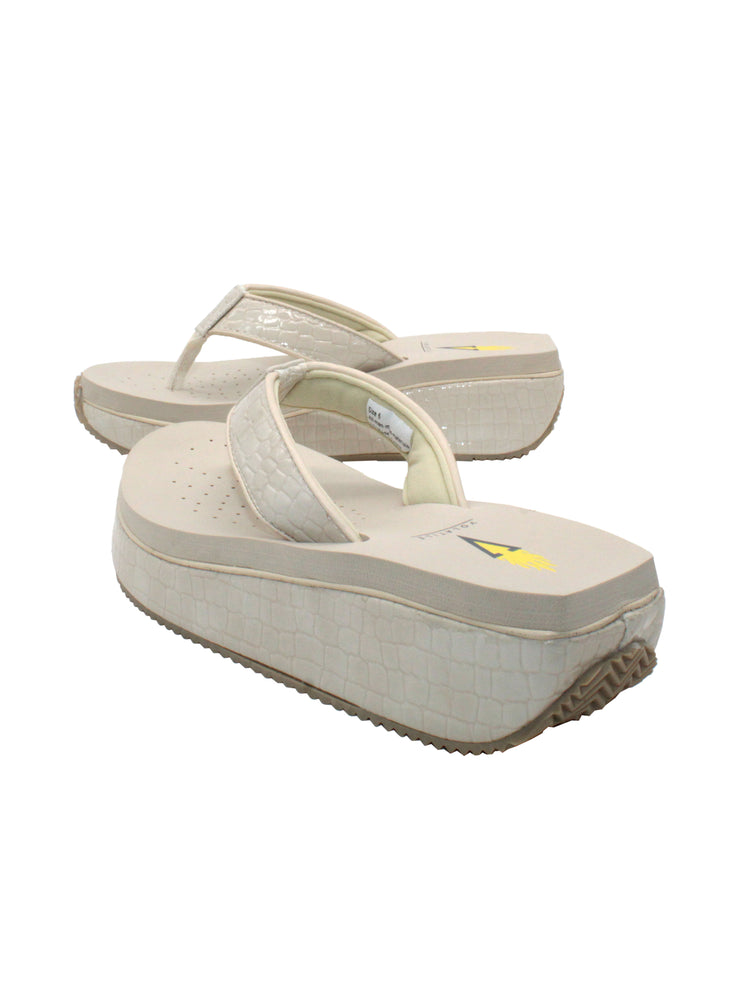 The Mini Croco thong wedge sandal by Volatile is crafted from a luxe, glossy faux crocodile material and gives a modest lift in height with the comfortable 1 1/2” wedge. They feature Volatile’s signature ultra comfort EVA insole for all day comfort, padded textile lining that rests gently on the skin, and nonskid rubber traction outsoles to keep feet grounded on all surfaces.  off white  4